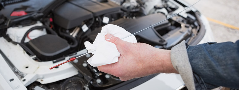 Mechanic cleaing the dipstick - Car Servicing Stockport