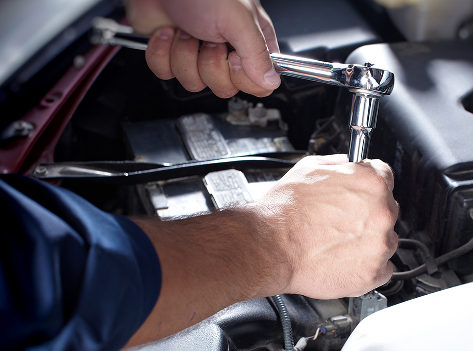 Mechanic looking at a car engine - Car Repairs Stockport