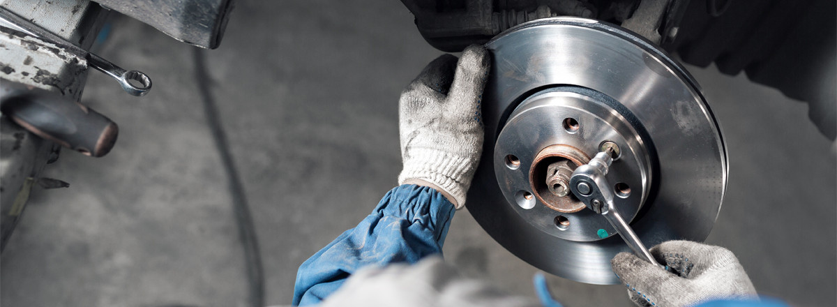 Mechanic fitting new brake pads - Brakes Stockport